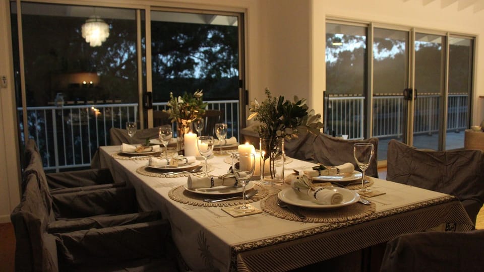 Set the scene for a candle lit dinner with seating for 8 guests.