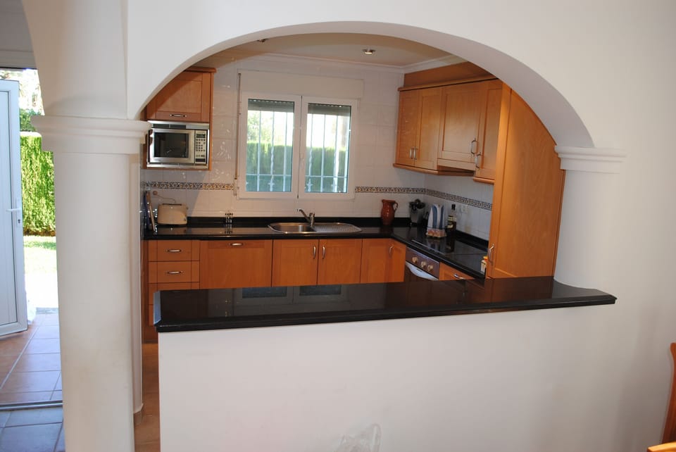 Looking at Kitchen through arch in Dining Area