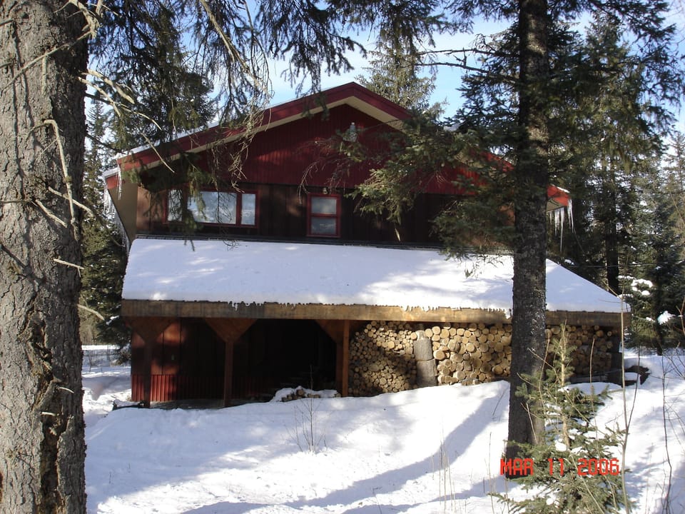 Winter shot of cabin side - lots of wood for the fire!