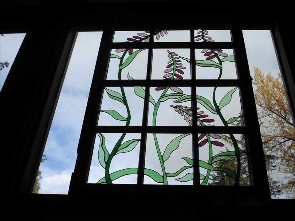 Custom artwork throughout lodge such as this stain glass window