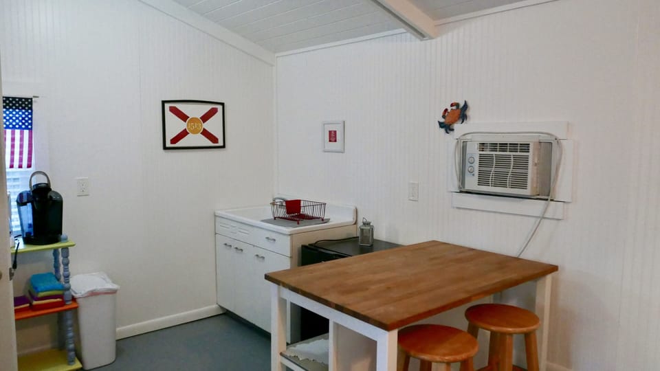 cottage kitchenette with sink, mini fridge and coffee maker