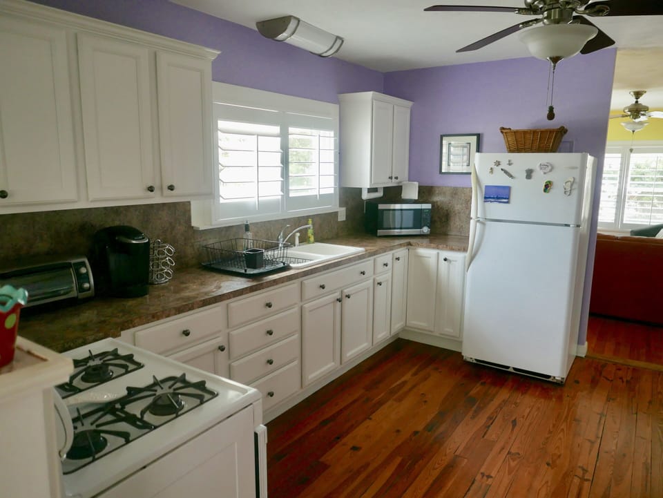 Kitchen with full size fridge/freezer, microwave, gas oven and stove top