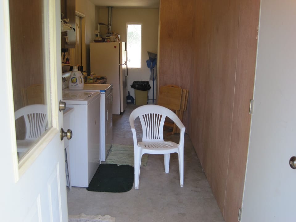 view looking into the laundry area from  the back yard