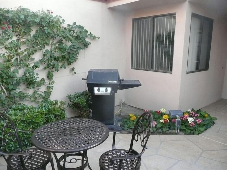 Entry courtyard with bistro set and 
BBQ.  