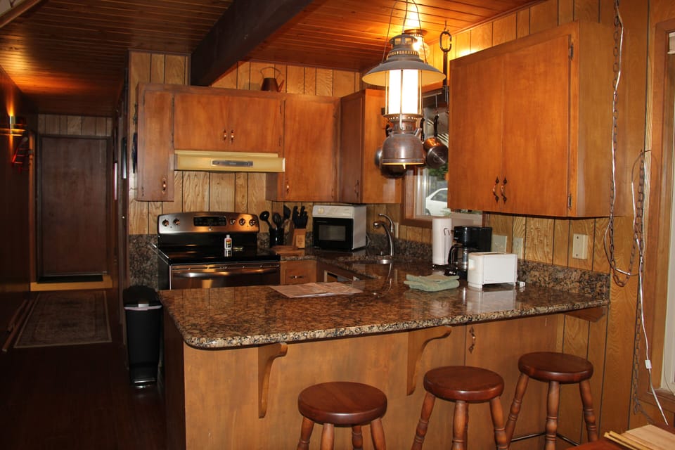 Modern Kitchen with granite counters connected to Living Room, Dining Area
