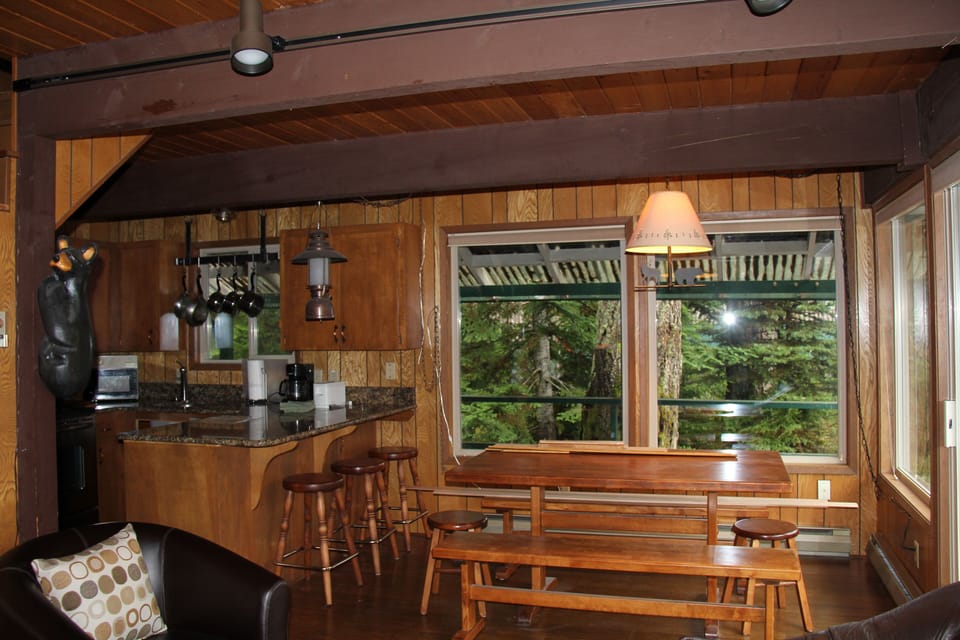 Dining Area is bright & cheery with views of trees for eating & games 