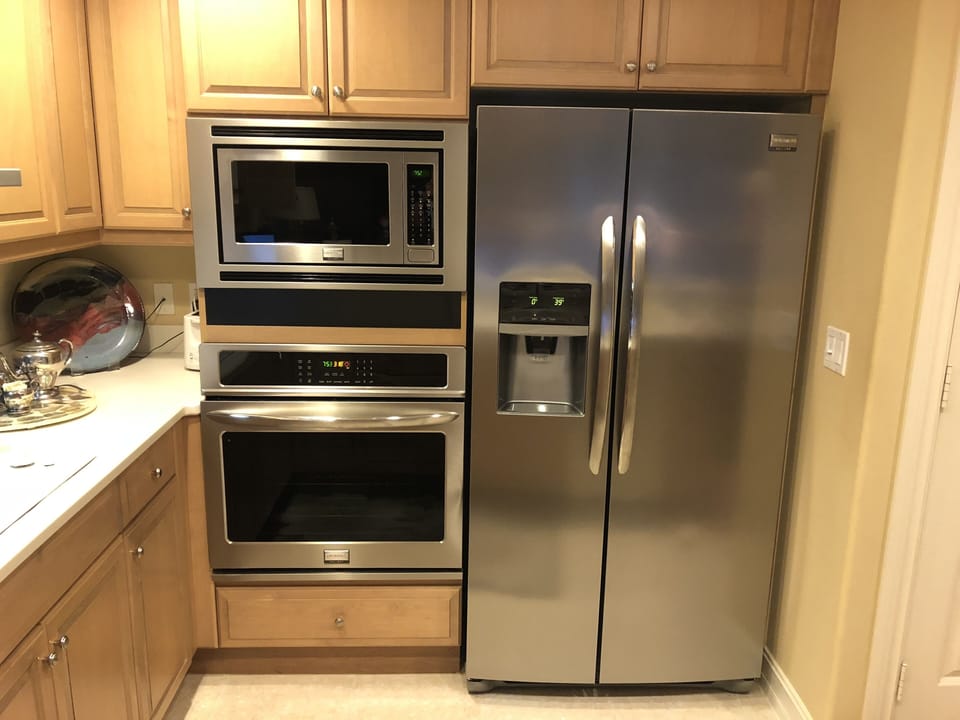 Updated appliances in kitchen as well as stacked washer and dryer behind closet.