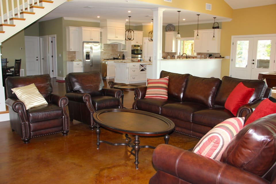 Open floor plan between living, dining, kitchen and game area