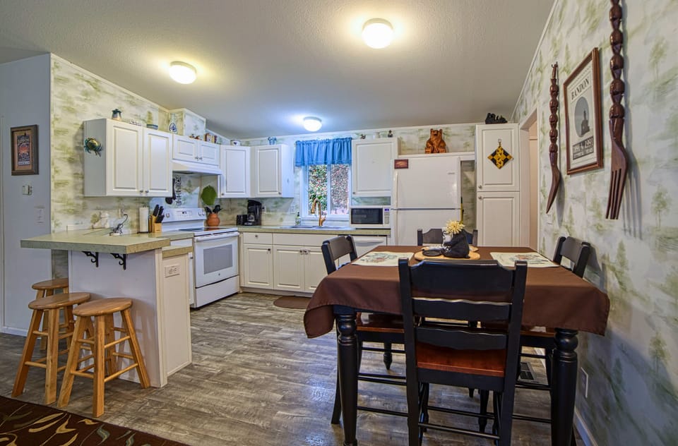 Kitchen has dining table with 4 chairs and almost all kitchen essentials.