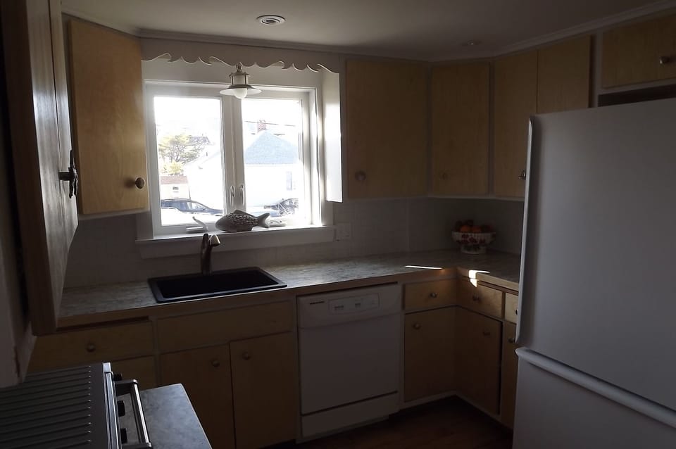 Kitchen has microwave and toaster over and of course a stove and refrigerator