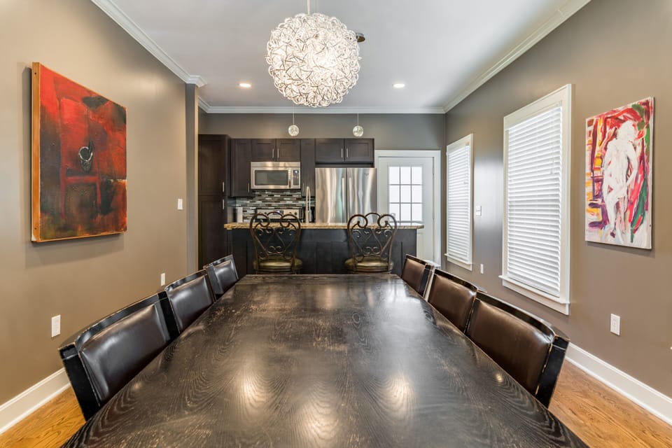 Dining Room with 8 seat table and Kitchen with 2 stool breakfast bar.
