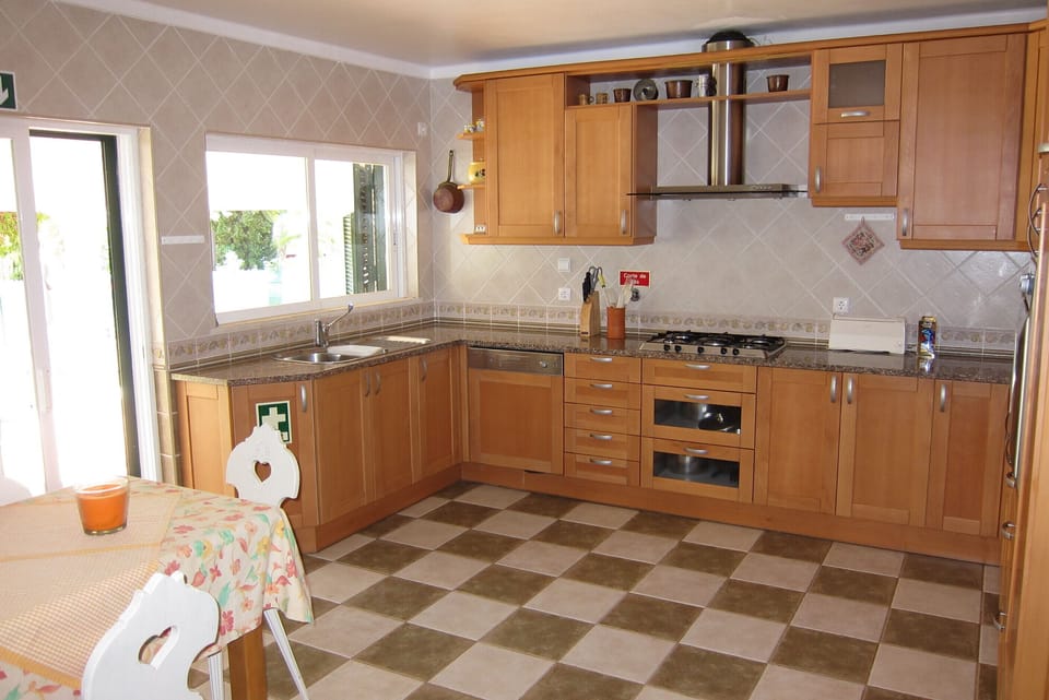 Large and fully equipped kitchen with sliding door to terrace and garden