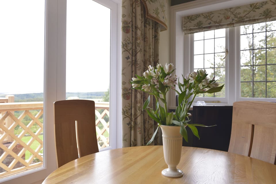 Patio doors from the dining area lead to the gardens