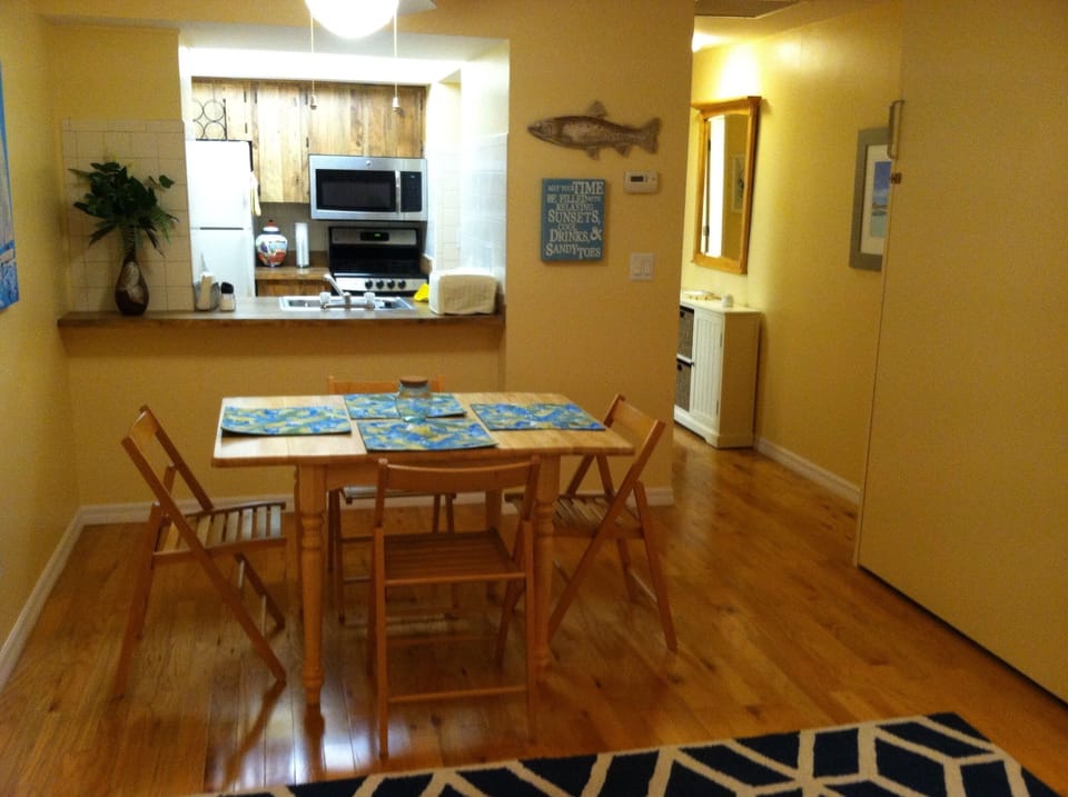Looking from living area to kitchen; Queen Murphy bed to right of table. 