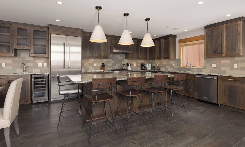 Your spacious gourmet kitchen welcomes you with rich wood cabinetry, granite countertops, and a large island perfect for gathering with friends.