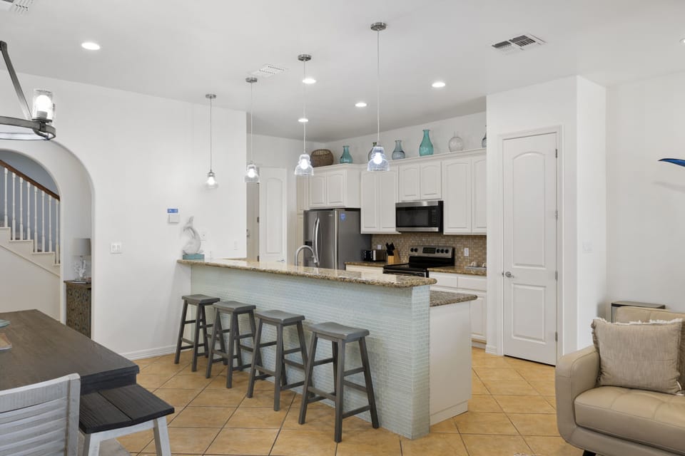 Large kitchen island with bar seating for four guests