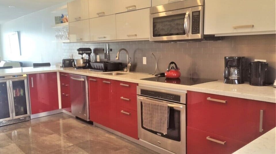 Premium Amenities: Includes a dual-zone wine and beverage cooler, integrated stainless steel appliances, and a glass coo