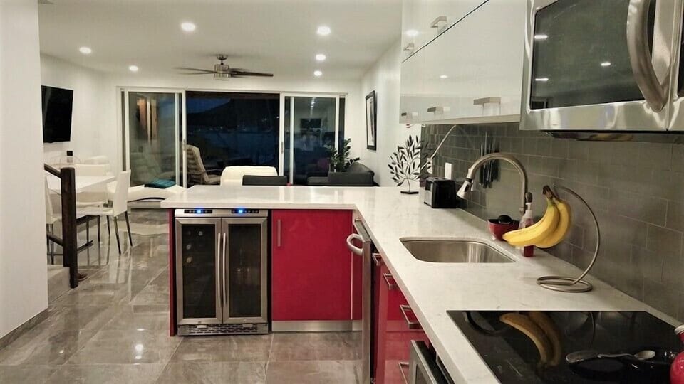 This sleek, contemporary kitchen combines high-end functionality with a vibrant, modern aesthetic. Perfect for travelers