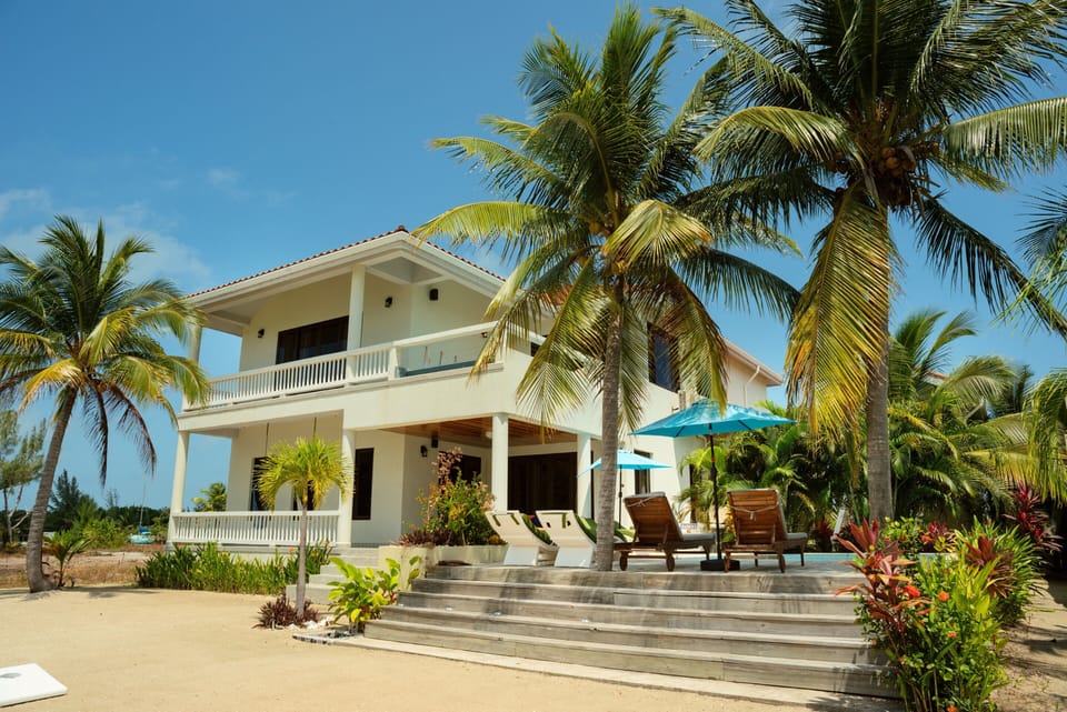 Beach staircase to ground level pool, back patio, and game room entrance.