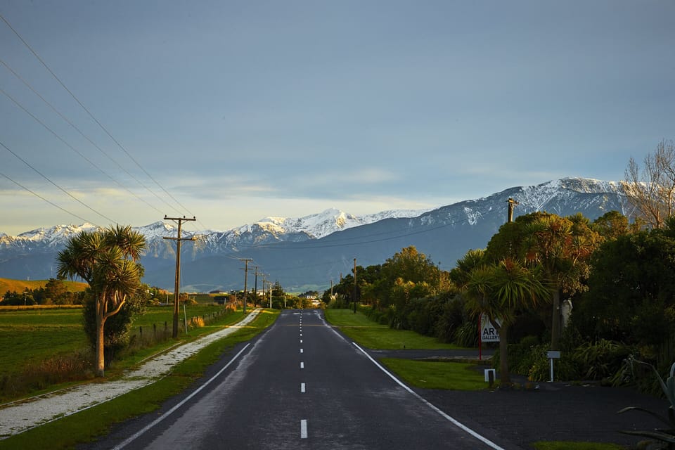 The road side view of farmlands and mountains