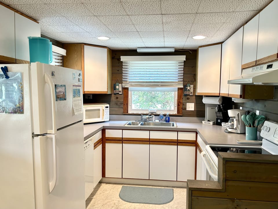 Well stocked kitchen with new windows & blinds