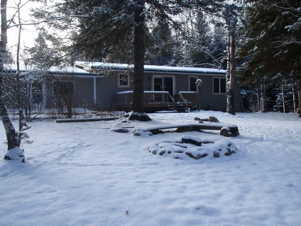 Cabin from the rivers edge in winter
