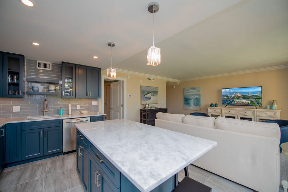 New kitchen with quartzite counters and stainless steel appliances.