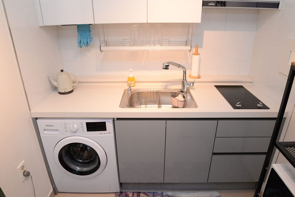 Kitchen with the sink and stove
