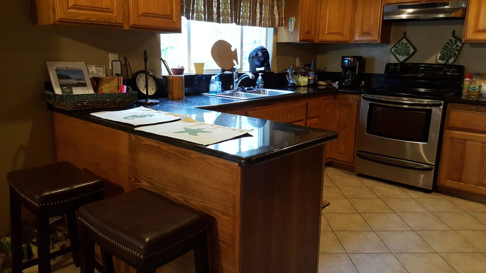 Fully stocked kitchen with breakfast bar