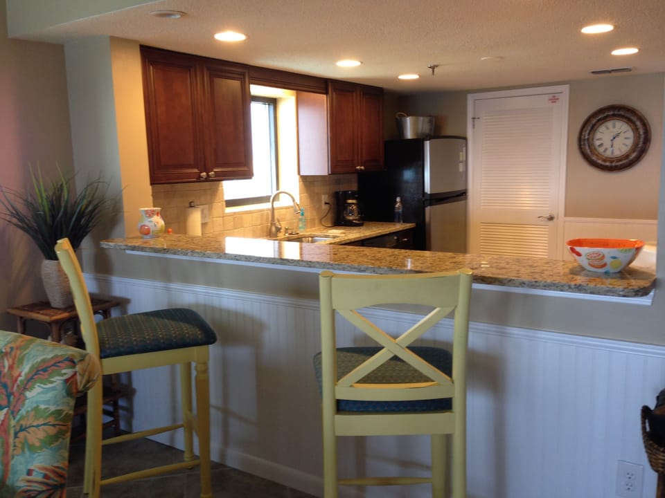 bar area looking back into kitchen , all new cabinets , granite counter tops 