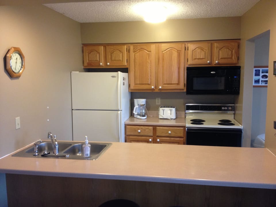 Kitchen has place settings for 16 and a full complement of cookware