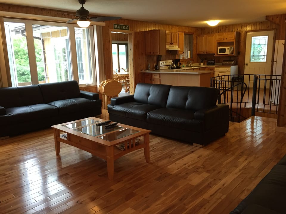 living room / kitchen area with large separate dining area overlooking the lake.