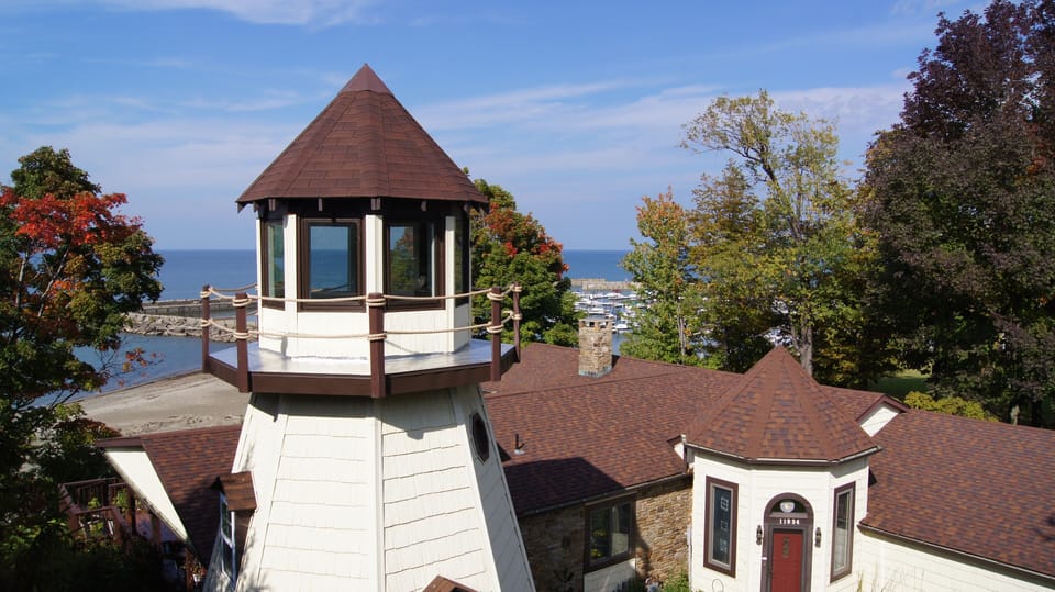 Aerial view of the front of our home, showing the beach+marina in background.