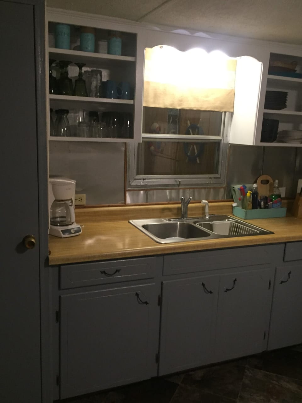 Open kitchen includes small appliances and dishware
