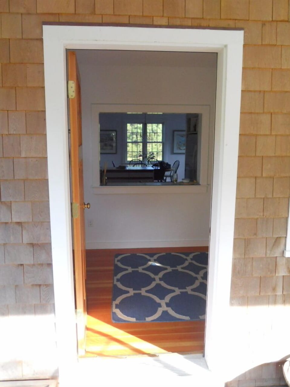 Entering our house, looking through the kitchen to the dining room and the pond.