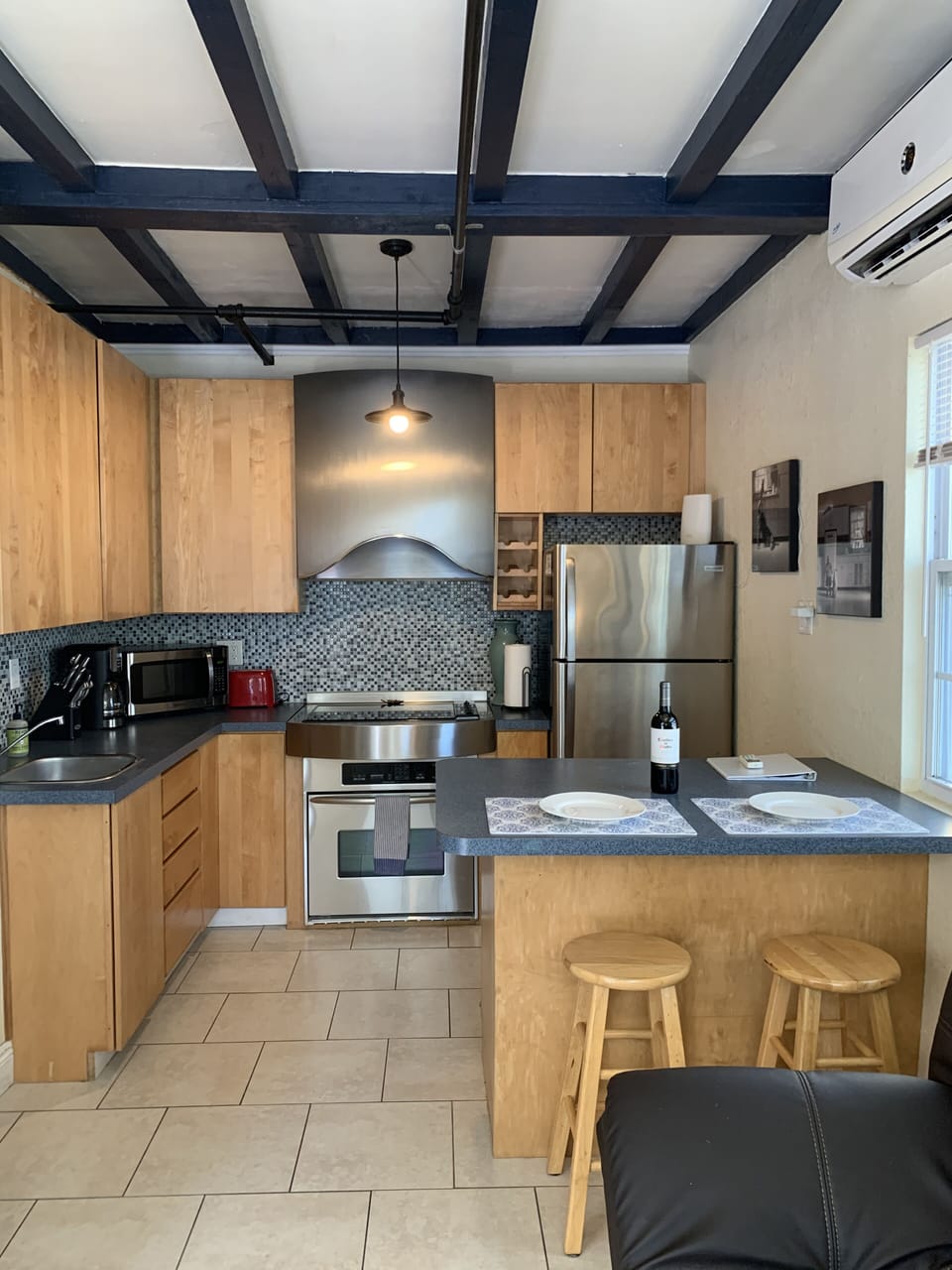 Open area full kitchen and breakfast bar 
