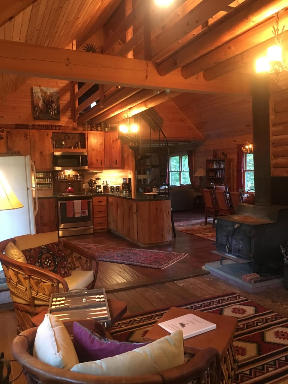View from cabin entrance towards kitchen/dining area and TV room behind. 