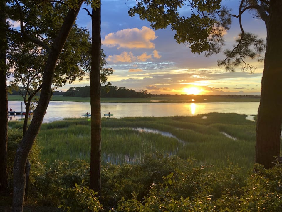 Sunset from the back deck with dock and kayakers
