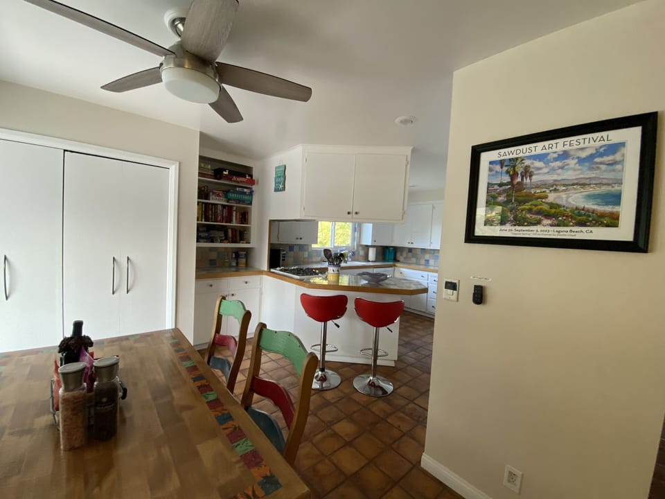 Eating Table seating four persons with two counter top stools
