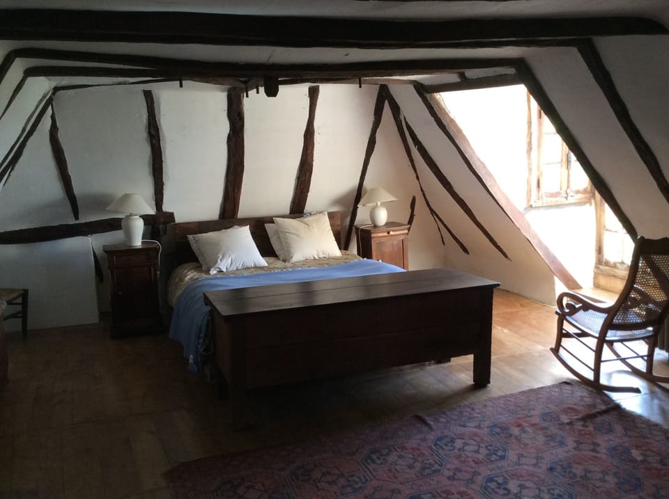 Master bedroom with original beams and large dormer window