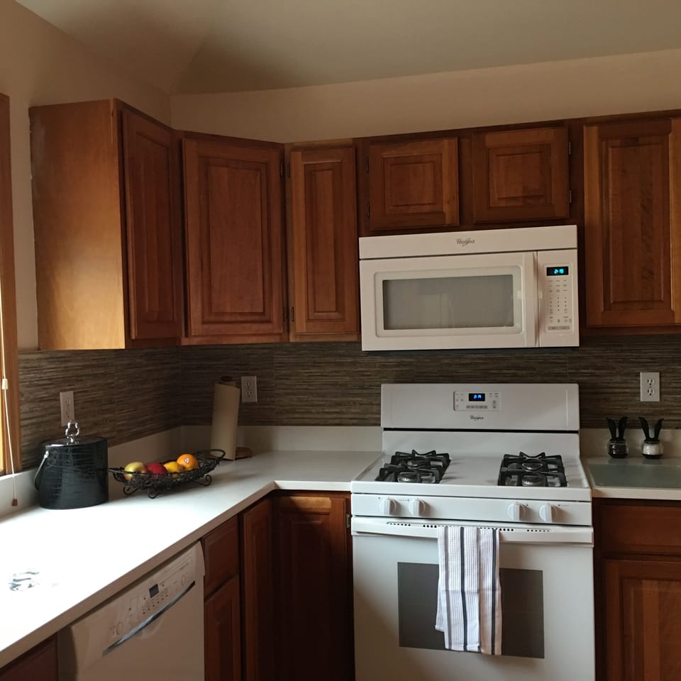 Cherry cabinets,  quartz countertops, gas range in fully stocked kitchen
