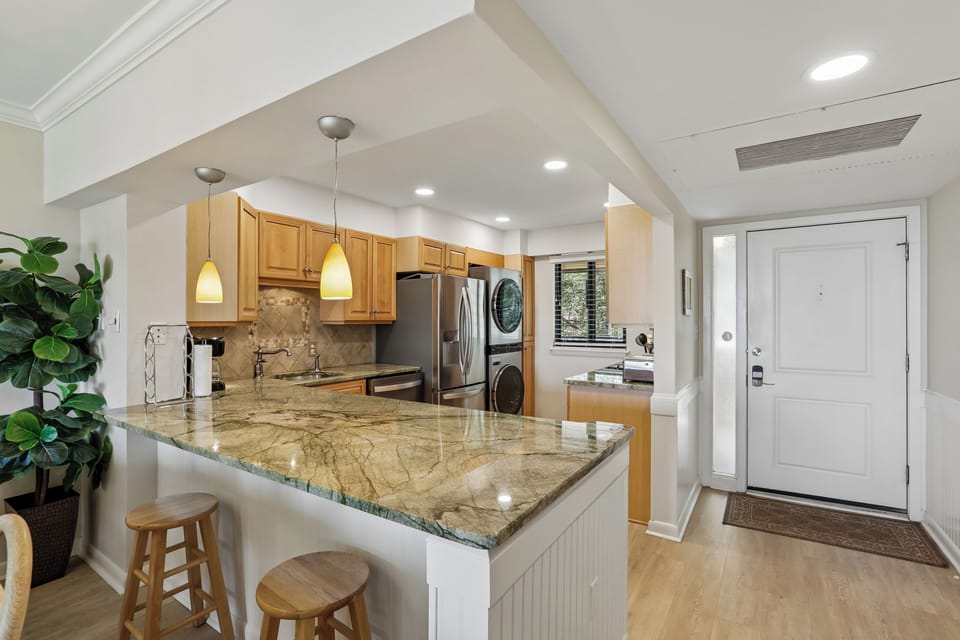 Your spacious, open-concept kitchen welcomes you with gleaming granite countertops, stainless steel appliances, and a breakfast bar perfect for morning coffee or casual meals.