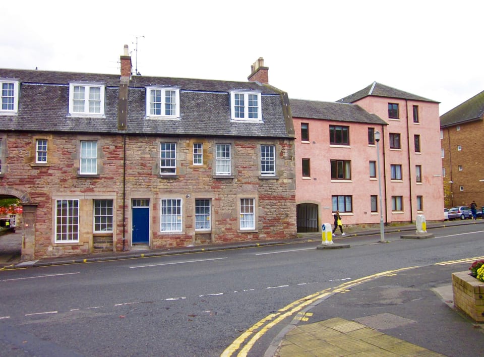 The apartment is the terracotta building on right