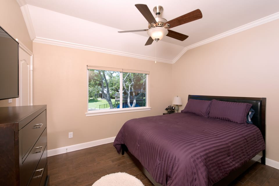 Bedroom #3 upstairs with 50" tv and beautiful lake view from the queen bed