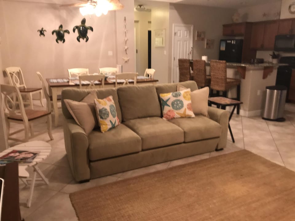Great room with queen sofa sleeper and dining table and kitchen bar seating