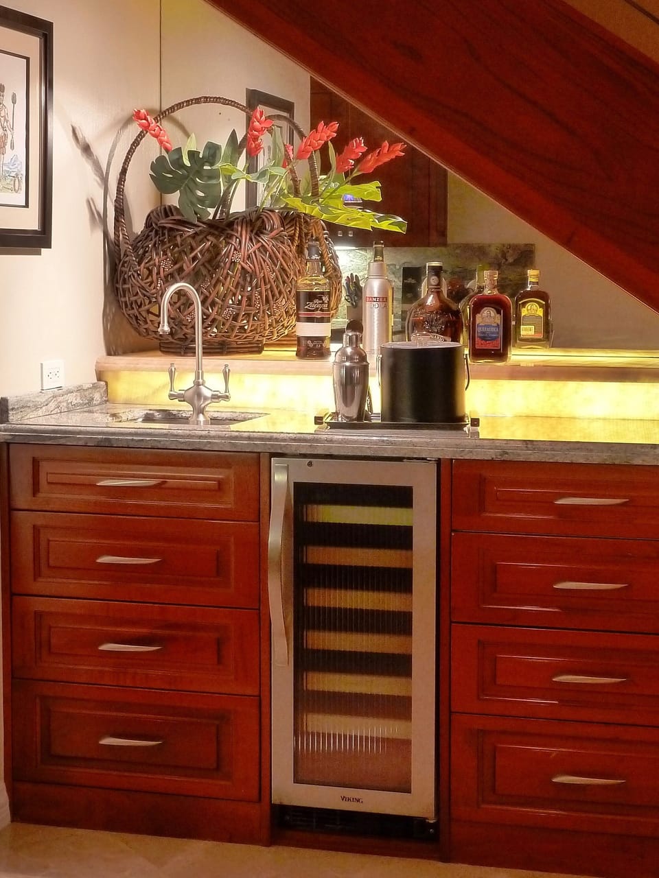 Wet bar with wine cooler. You'll also find a first-aid kit here, just in case.
