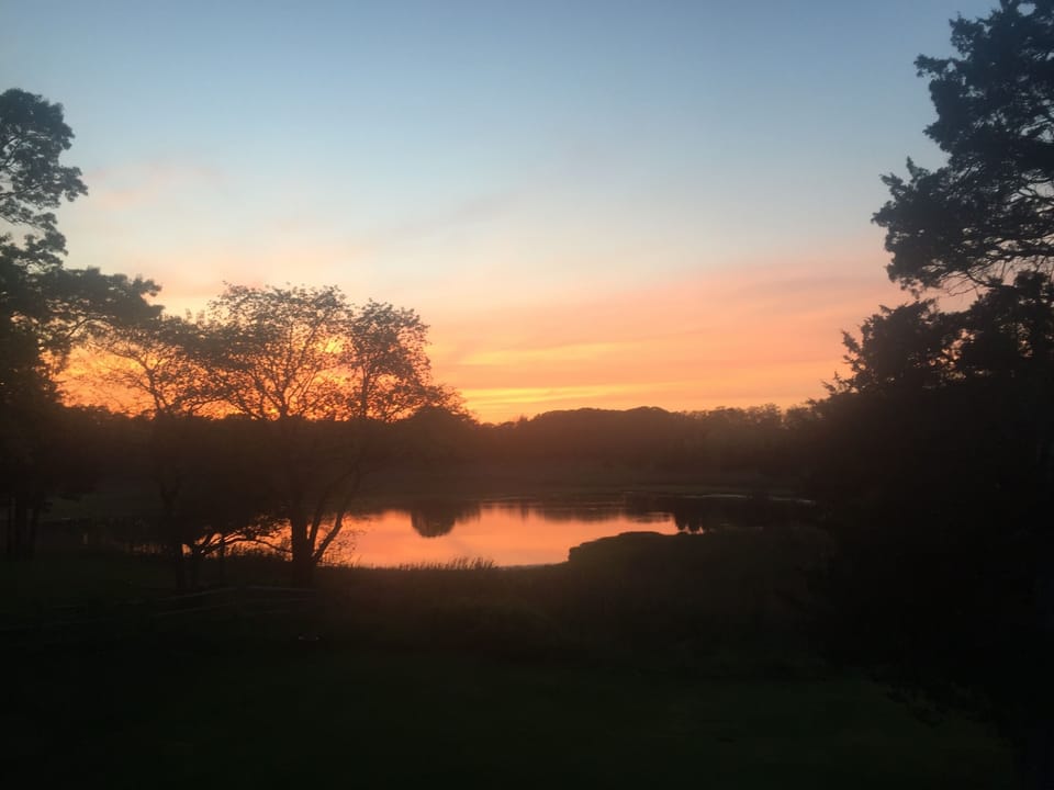 Sunset over our back pond. View from our deck off master bedroom.