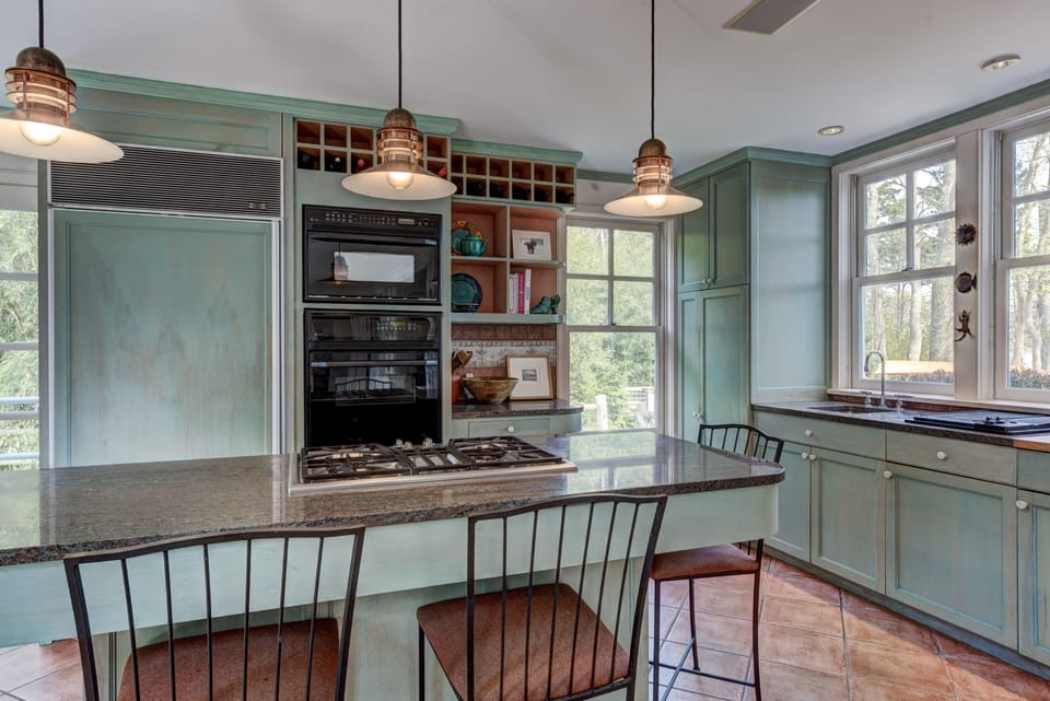 Spacious kitchen with views of both ponds and island seating.