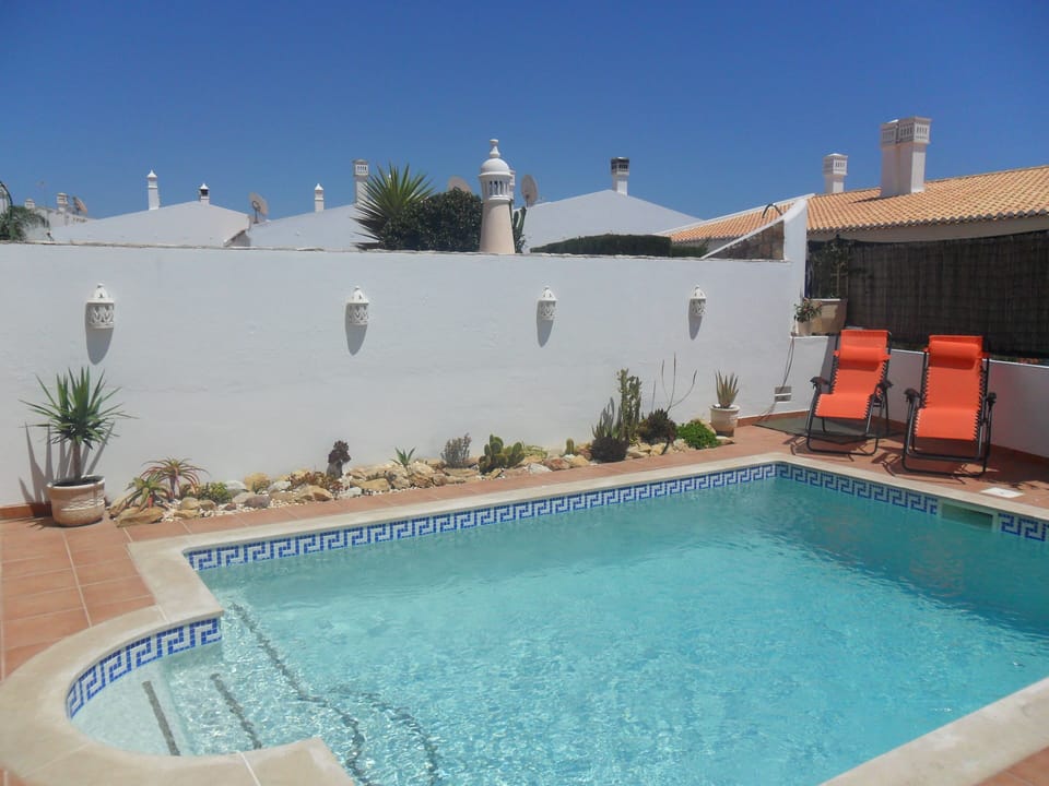 Pool and reclining sun loungers
