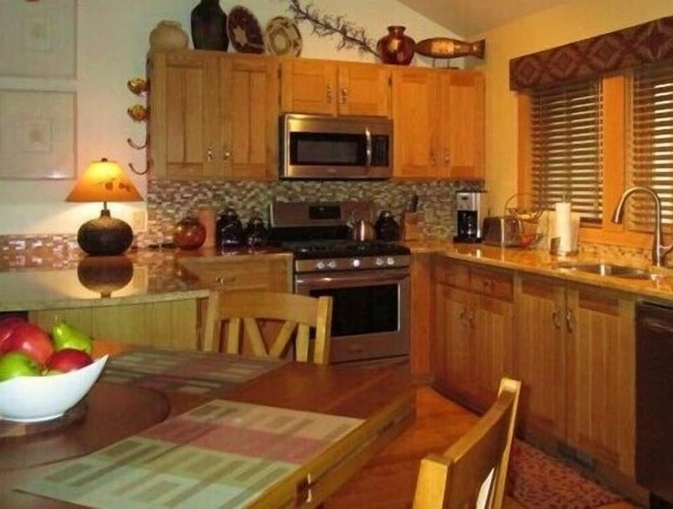 Warm and inviting kitchen with bar-height table that can seat up to 8.
